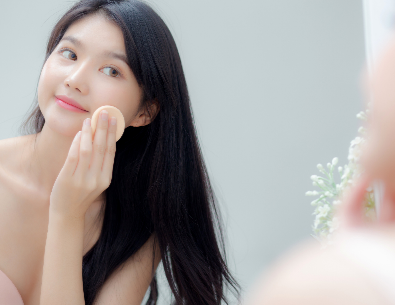 Woman putting on makeup